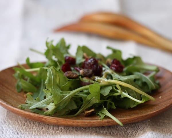 Plated arugula salad with cranberries and dressing; highlighting the nutrition events happening and Mind Body Soul Kelowna