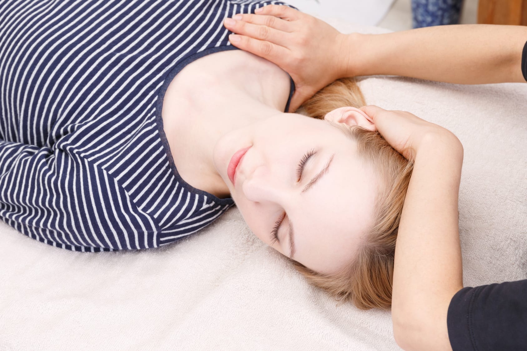 Practitioner performing muscle testing at a spa on a woman patient