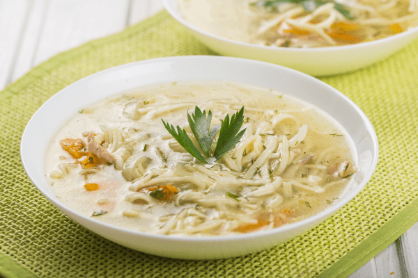Delicious Chicken Zoodle Soup in a bowl, garnished with parsley