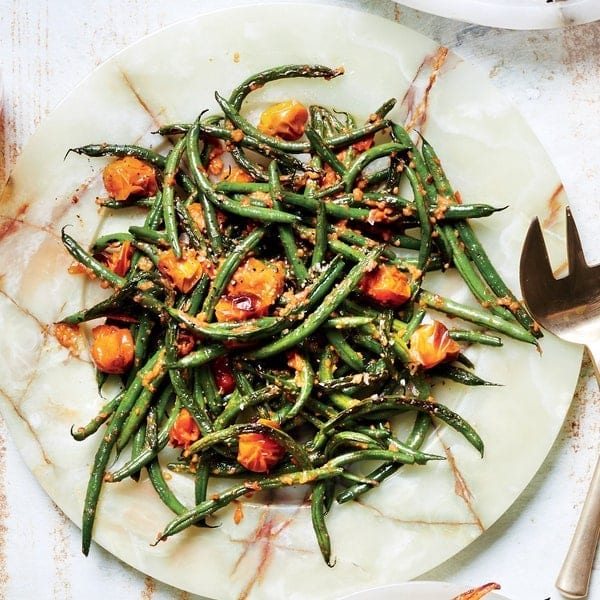 Vegetarian Romesco Roasted Potatoes and Green Beans plated on a marble platter